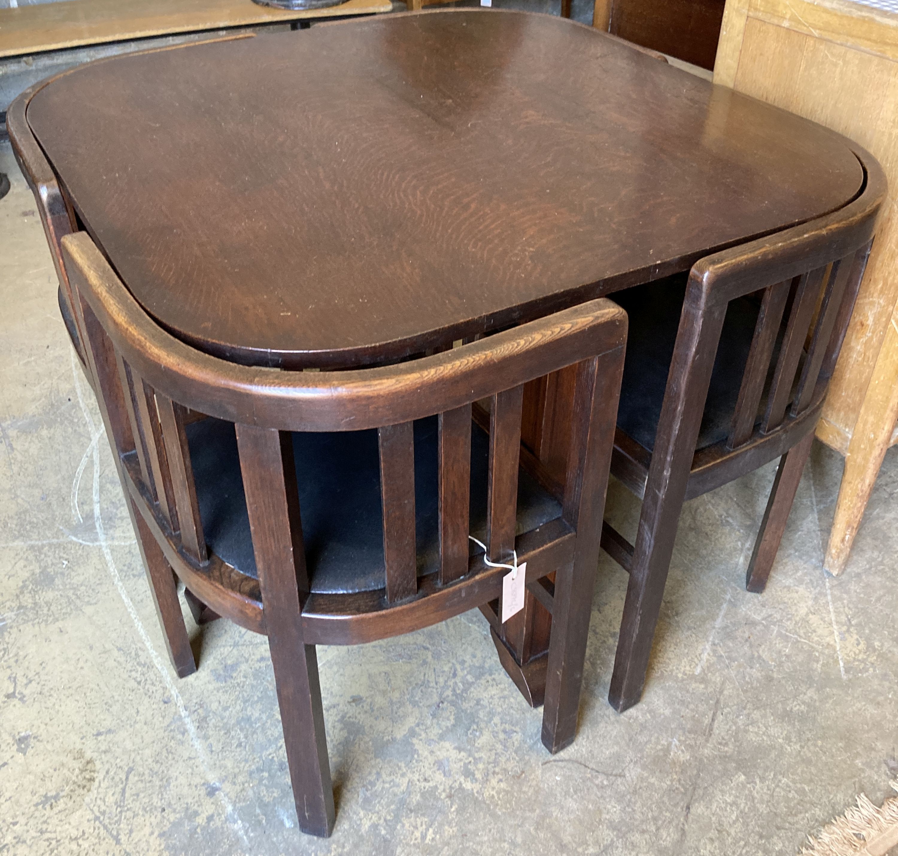 A Heals style oak table, length 92cm, depth 92cm, height 74cm and four chairs